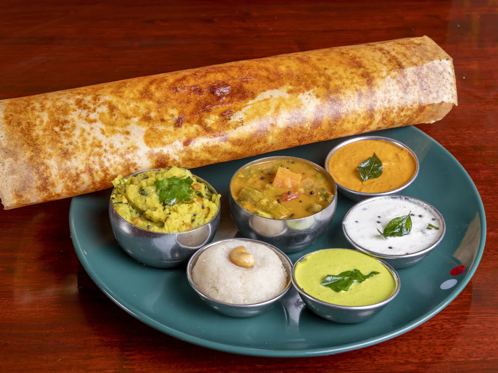 A South Indian dosa served with chutney and sambar