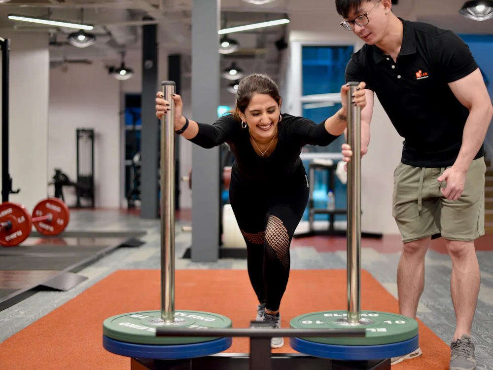 A trainer coaching a session at a gym