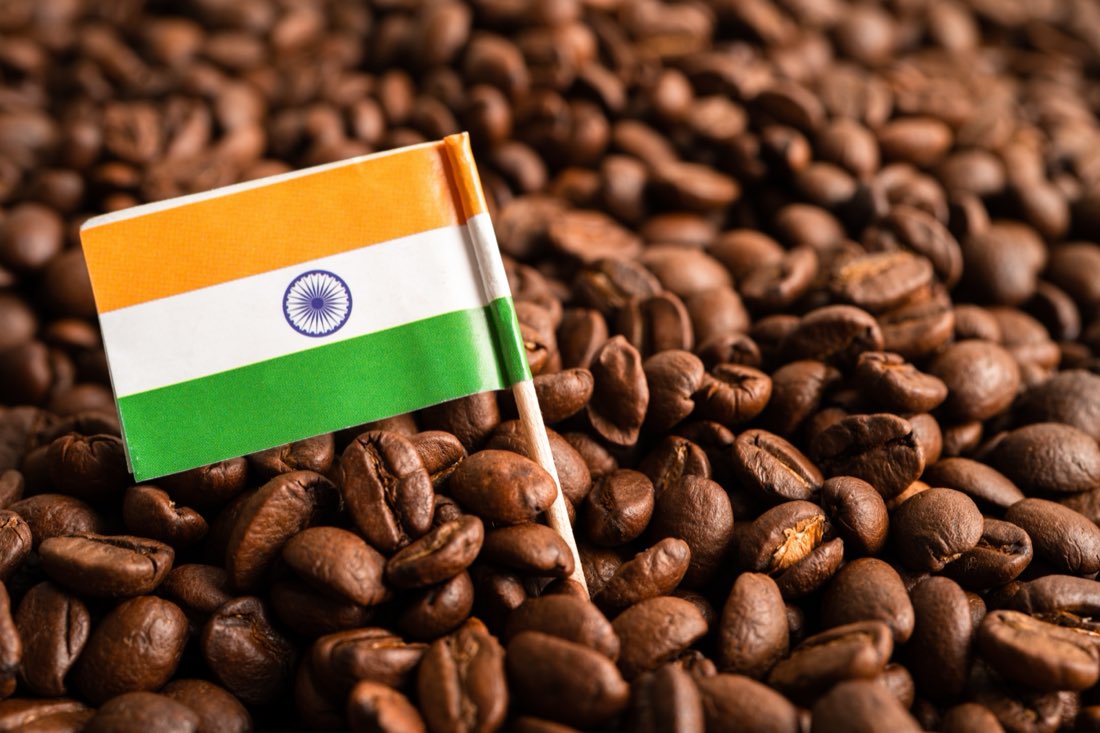 Roasted coffee beans with a small Indian flag
